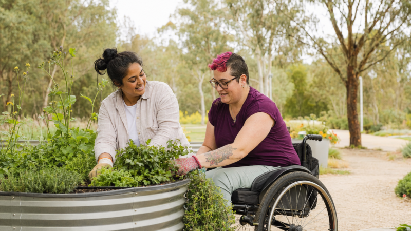 NDIS community participation support with a participant and support worker gardening in Canberra