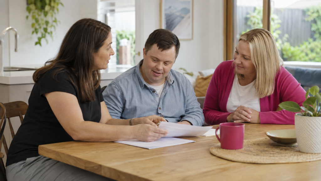 Adult with disability reviewing a SIL service agreement with trusted supporters